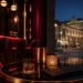 Elegant Vienna bar counter at night with city lights in the background