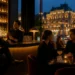 Elegant Vienna bar interior showing counter stools in the foreground and soft lit tables along the wall